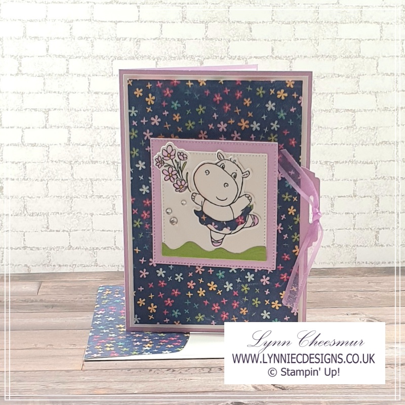 Front of a Tab pull Flap card with a dancing hippo holding a bunch of flowers 